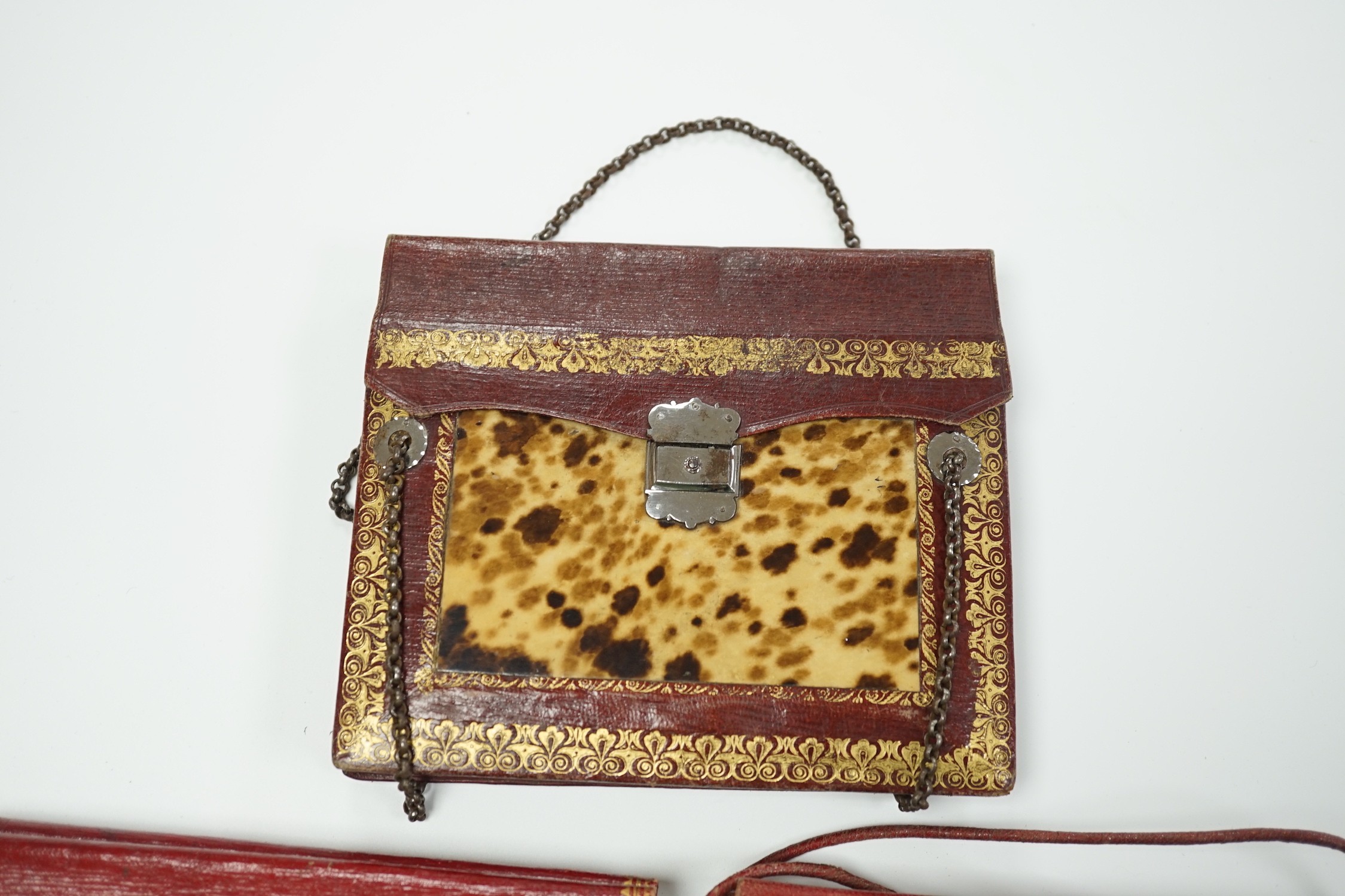 Three rare William IV red and burgundy tooled Moroccan leather and tortoiseshell panelled handbags, two with Scottish thistle shaped cut steel clasps